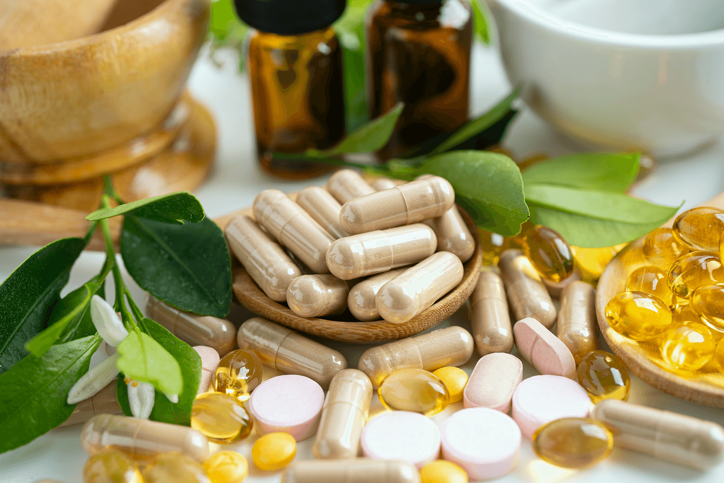 Various supplement bottles and capsules arranged on a table